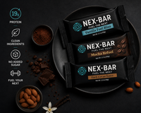 Nex-Bar protein bars on a dark surface with ingredients and branding details.